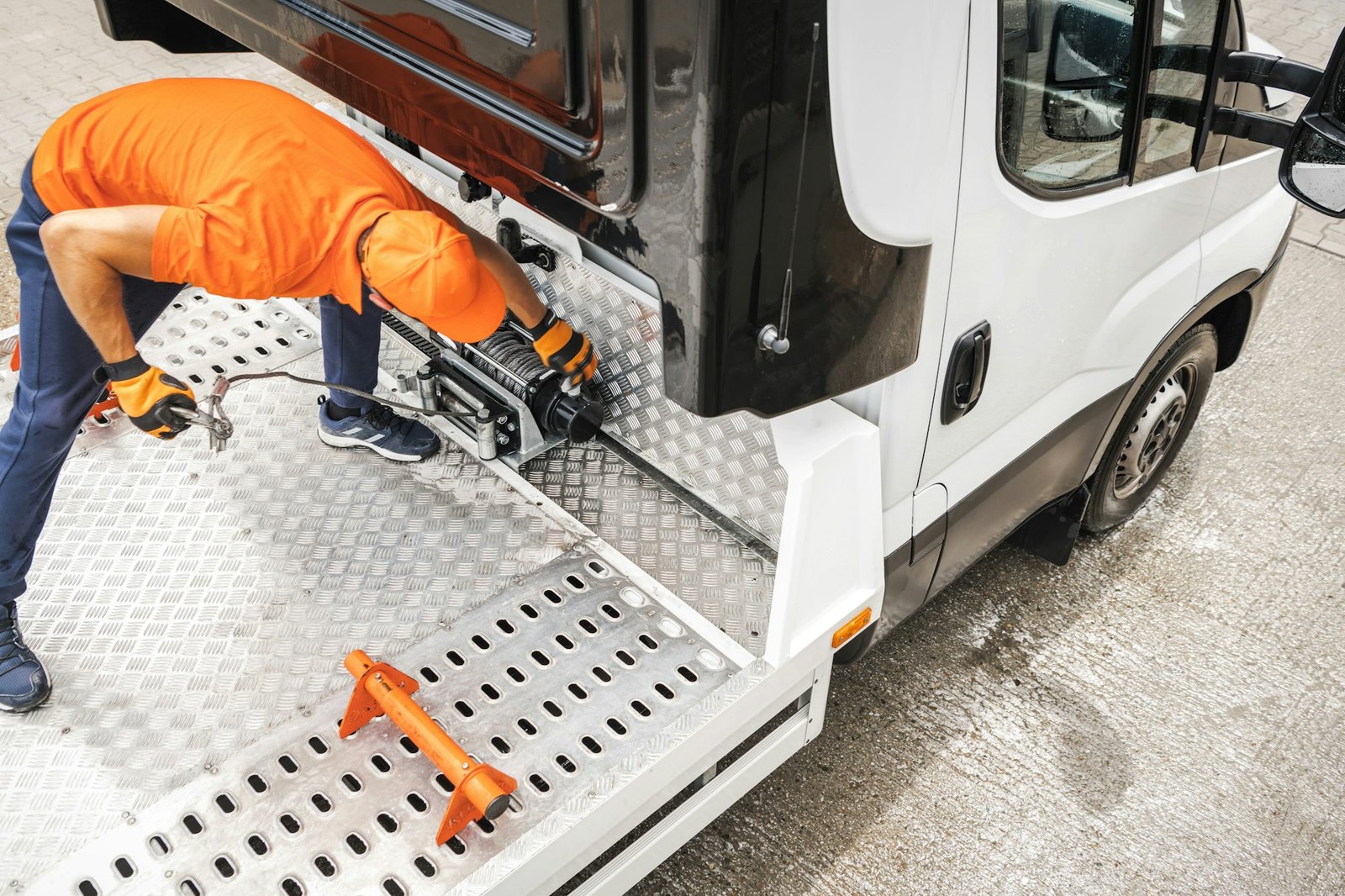 Tow Truck Driver Getting Ready to Load the Car Using Winch Device